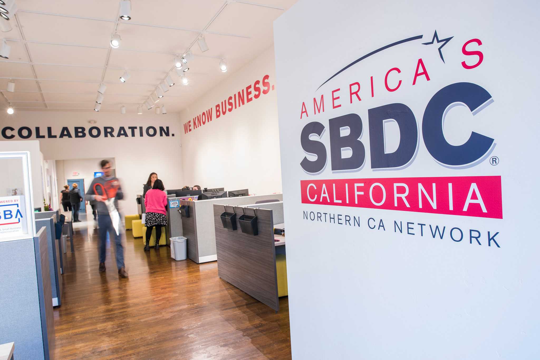 Large California SBDC wall identity and lettering throughout an active Northern California network office.